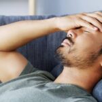 Person lying down during the day but unable to fall asleep despite feeling tired