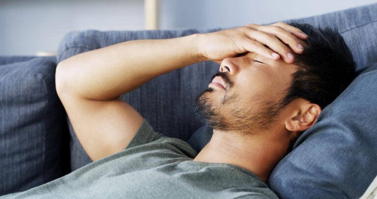 Person lying down during the day but unable to fall asleep despite feeling tired