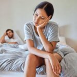 Person overthinking in bed after a stressful argument at night