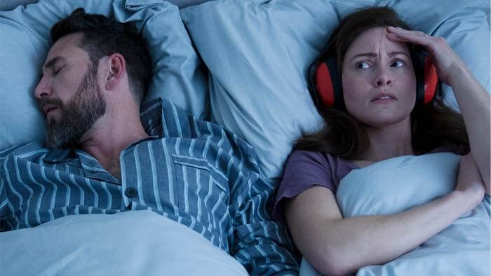 Person unable to sleep in a quiet bedroom using background noise