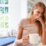 Person feeling nauseous after drinking coffee on an empty stomach