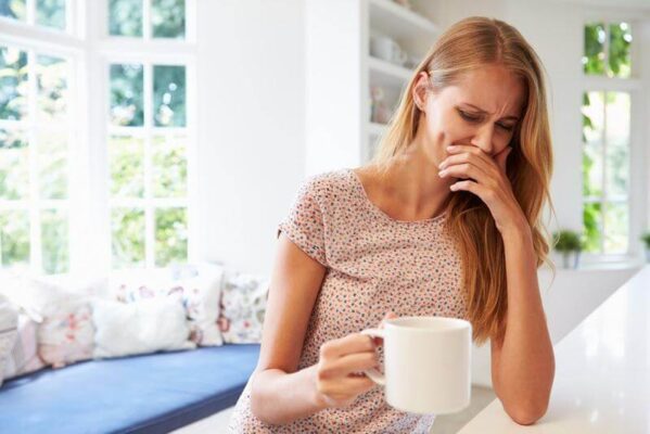 Person feeling nauseous after drinking coffee on an empty stomach