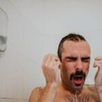 Person reacting to sudden cold shower shock