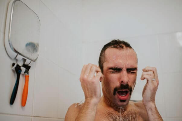 Person reacting to sudden cold shower shock