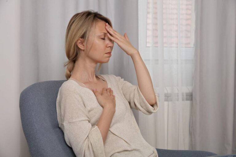Person feeling dizzy during deep breathing exercise