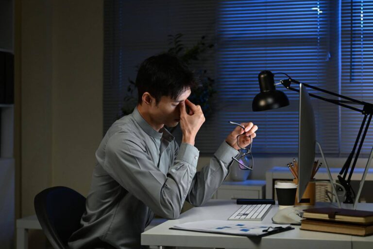 Person experiencing heavy eyes and eye strain without feeling sleepy