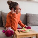 Person feeling uneasy and anxious after eating a meal at home