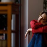 Person sitting quietly after crying and feeling lightheaded