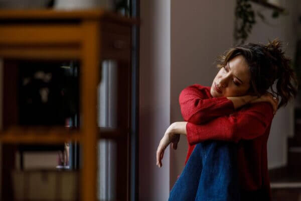 Person sitting quietly after crying and feeling lightheaded