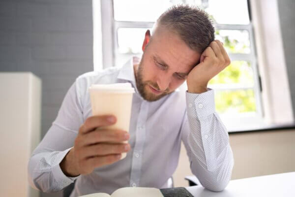 Person feeling lightheaded after drinking coffee in the morning
