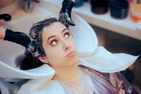 Woman feeling dizzy after getting a haircut at a salon
