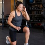 Person experiencing lightheadedness during lunges at the gym