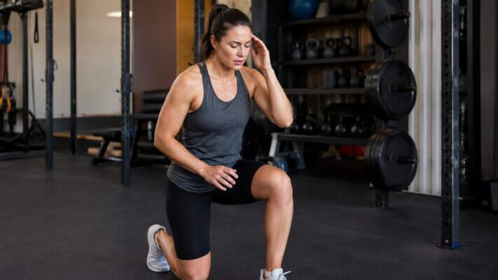 Person experiencing lightheadedness during lunges at the gym