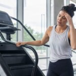 Person feeling dizzy after stepping off a StairMaster machine