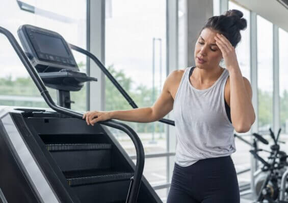 Person feeling dizzy after stepping off a StairMaster machine
