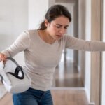 Person feeling dizzy after using a VR headset and trying to regain balance