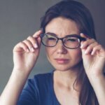 Person feeling dizzy and uncomfortable after wearing new glasses