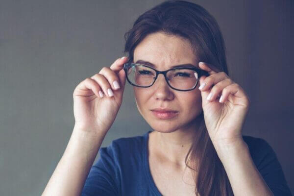 Person feeling dizzy and uncomfortable after wearing new glasses