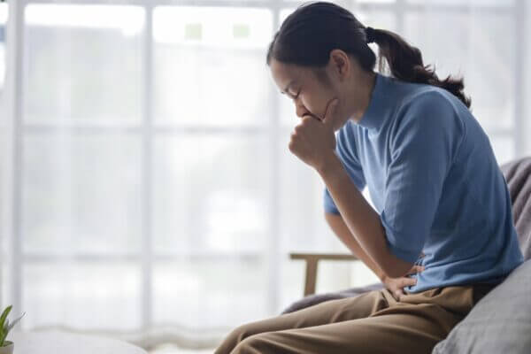 Person feeling nauseous and emotionally overwhelmed after crying