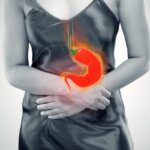 Person experiencing reflux and nausea after spicy food