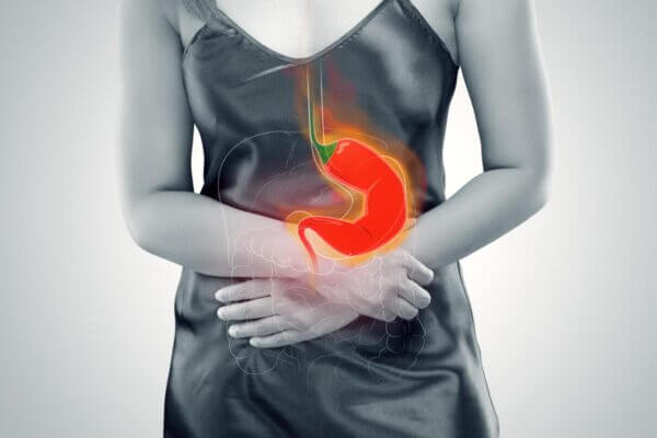Person experiencing reflux and nausea after spicy food