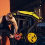 Person feeling nauseous and exhausted after an intense leg workout at the gym