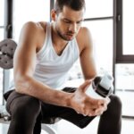 Person feeling nauseous after drinking a protein shake after workout