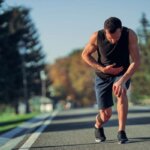 Runner feeling nauseous and breathing heavily after a hard run outdoors