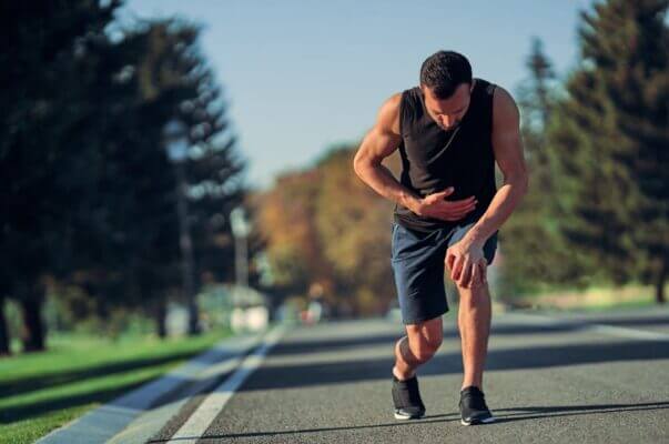 Runner feeling nauseous and breathing heavily after a hard run outdoors