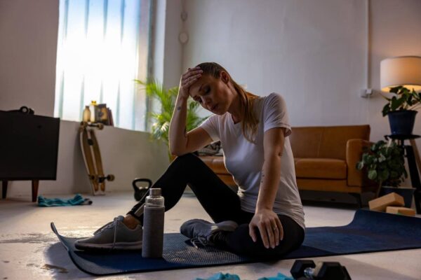 Person feeling nauseous and dizzy during deep stretching routine