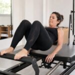 Person experiencing mild muscle shaking during a reformer Pilates exercise