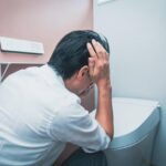 Person experiencing dizziness and weakness after pooping