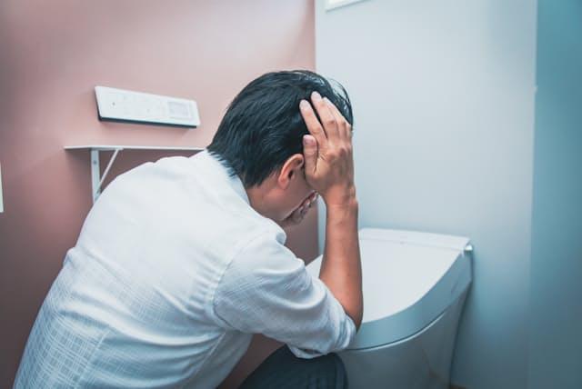 Person experiencing dizziness and weakness after pooping