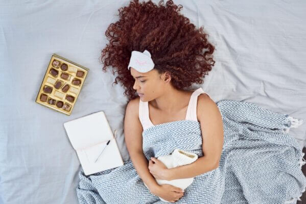 Person feeling nauseous after eating chocolate at home