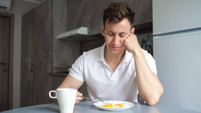 Person feeling sleepy and fatigued after eating an egg breakfast