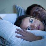 Person suddenly feeling awake in bed after being sleepy earlier