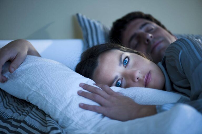 Person suddenly feeling awake in bed after being sleepy earlier