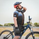 Cyclist holding the back of the neck after a bike ride