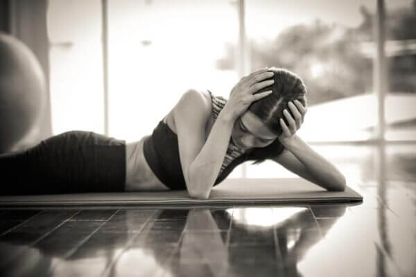 Person holding the back of the head after stretching because of neck tension and headache