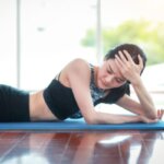 Woman feeling overheated and fatigued after hot yoga class
