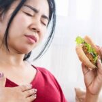 Person feeling heart racing and uneasy after eating a meal