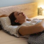 Person lying awake in bed after feeling sleepy earlier