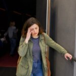 Person feeling dizzy after leaving a movie theater lobby