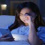 Person squinting while scrolling on a smartphone screen