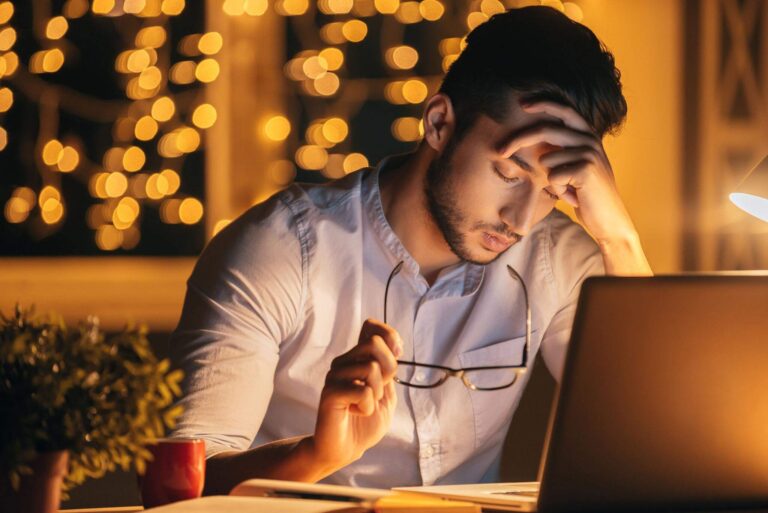 exhausted person awake in bed late at night despite feeling tired all day