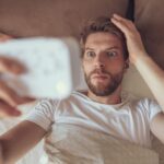 Person waking up before the alarm feeling anxious in a dark bedroom
