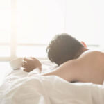 Person waking up exhausted after vivid dreams and restless sleep