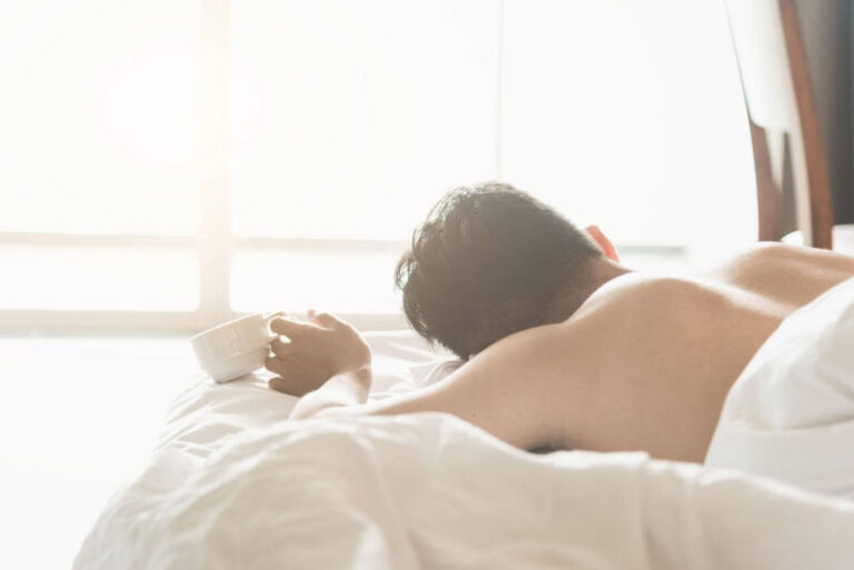 Person waking up exhausted after vivid dreams and restless sleep