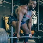 Athlete straining during a heavy deadlift with visible full-body tension