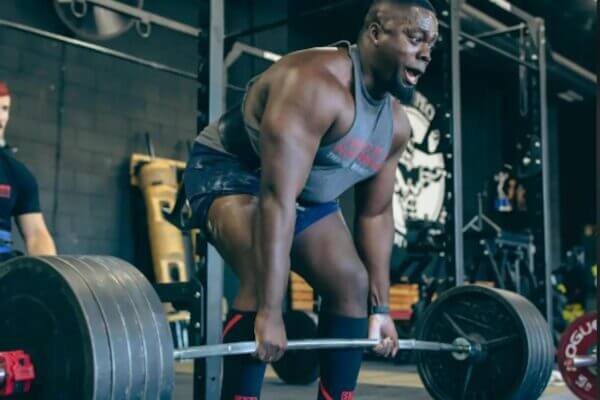 Athlete straining during a heavy deadlift with visible full-body tension